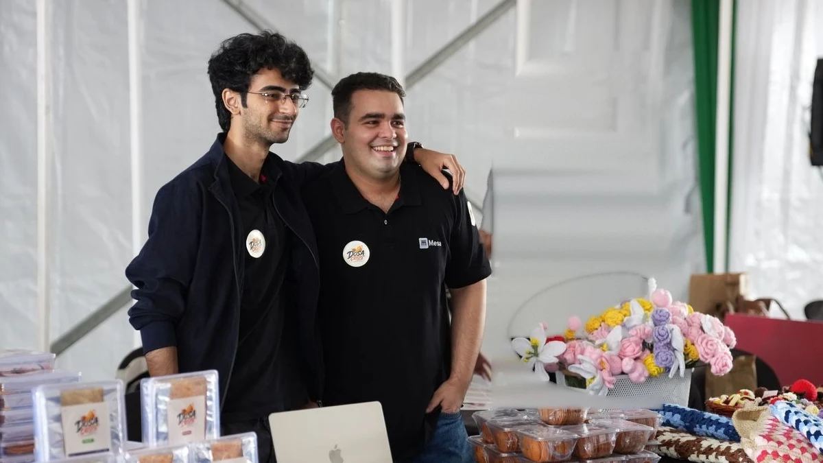 Two Mesa students at the stall for the business they built