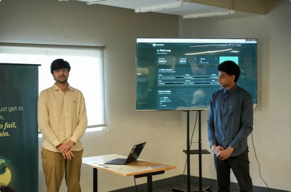 Two students demoing their product on a screen