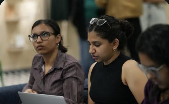Two students working on laptops during a sprint
