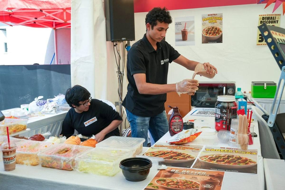 Two student founders running their Be Better protein bowl and shake stall