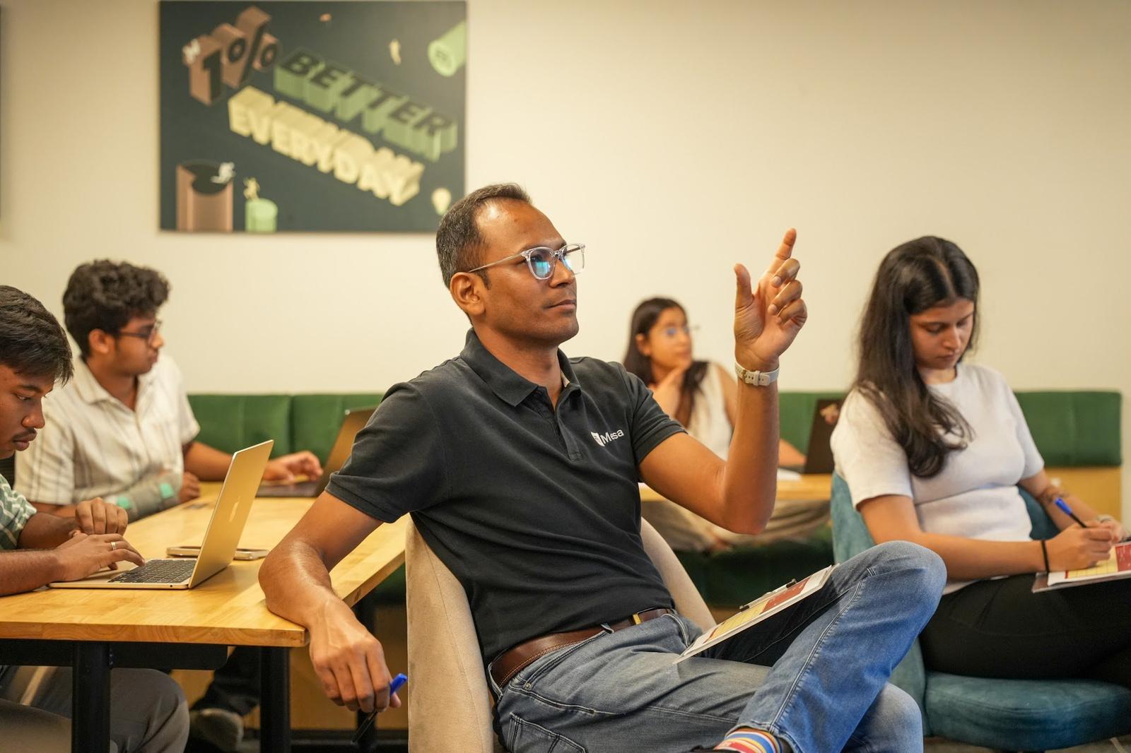 Founders working at their laptops during a class session