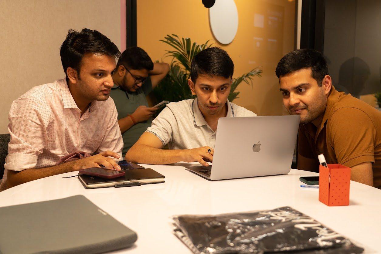 Founders gathered around a laptop during a working session