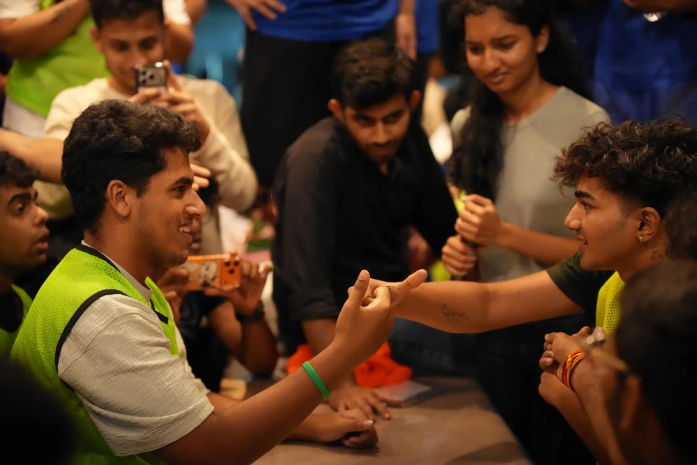Students cheering on an arm-wrestling match