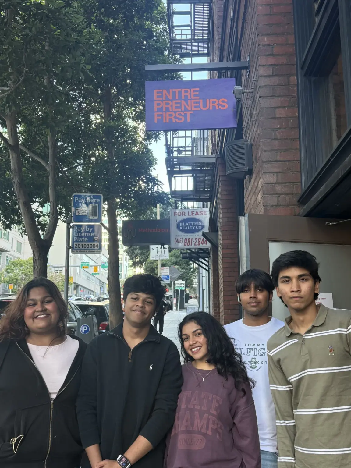 Mesa School undergraduate students on the street below the Entrepreneur First sign in San Francisco