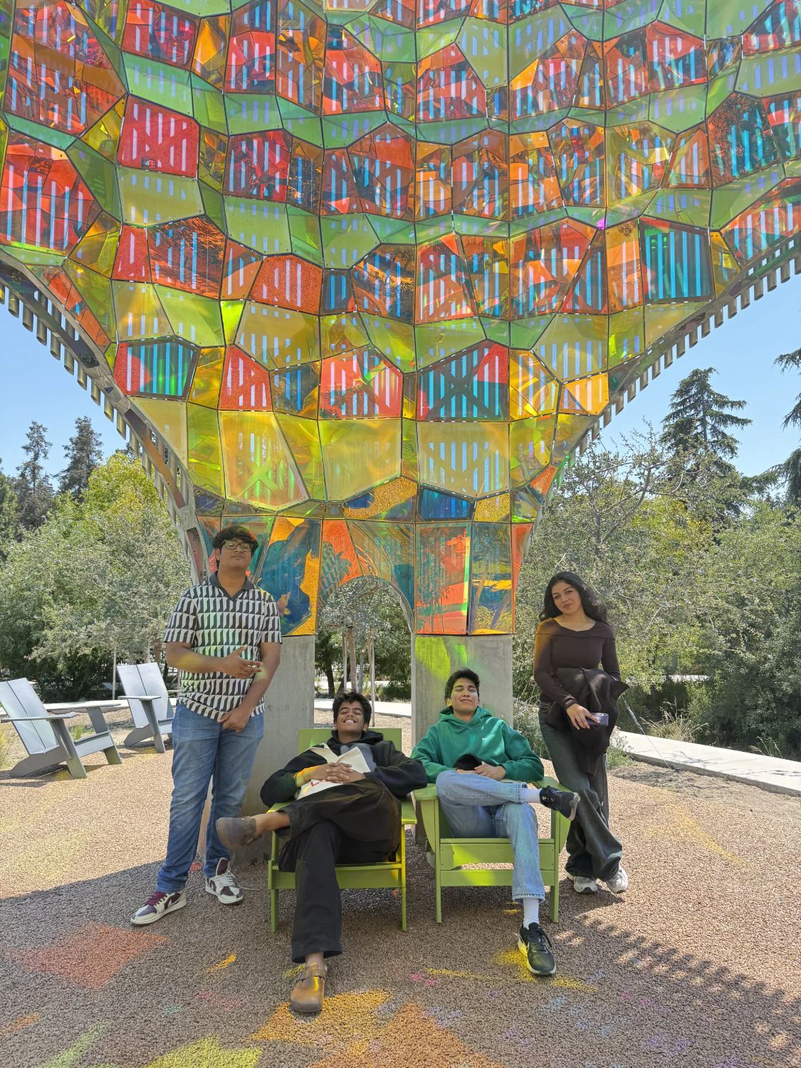 Mesa School undergraduate students under a colourful glass pavilion